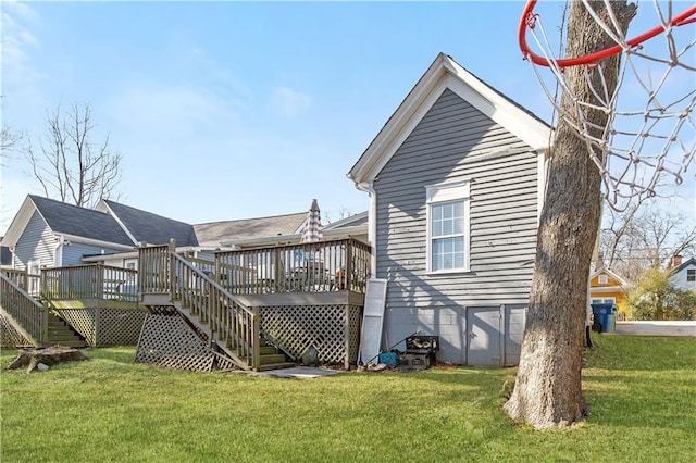 back of house featuring a deck and a yard