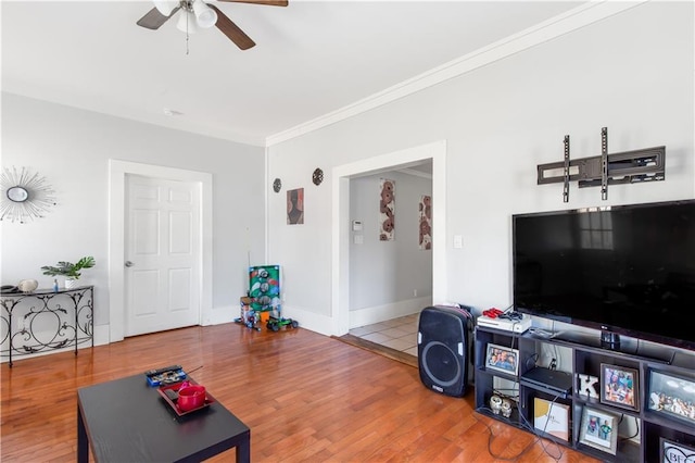 living room featuring ceiling fan, crown molding, and hardwood / wood-style flooring