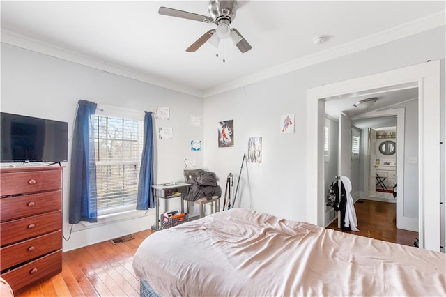 bedroom featuring ceiling fan, ornamental molding, and hardwood / wood-style floors