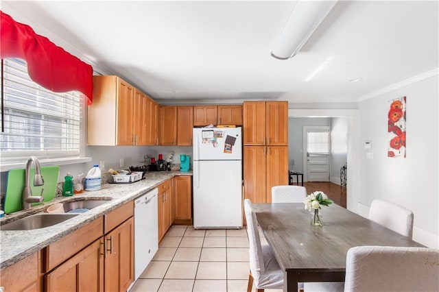 kitchen featuring light stone countertops, white appliances, sink, ornamental molding, and light tile patterned flooring