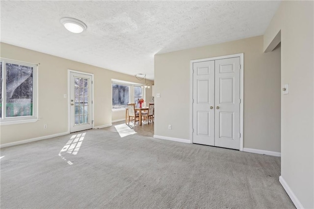 1056 Shadow Lake Dr, Lithonia, GA 30058 - unfurnished living room with carpet and a textured ceiling
