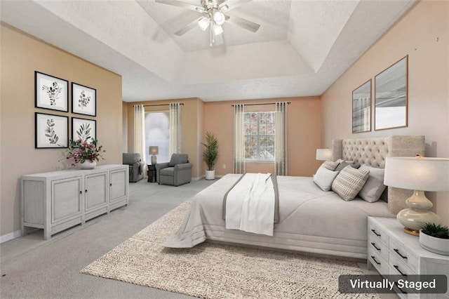 1056 Shadow Lake Dr, Lithonia, GA 30058 - bedroom with light carpet, a tray ceiling, and a ceiling fan