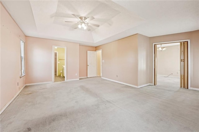 1056 Shadow Lake Dr, Lithonia, GA 30058 - unfurnished bedroom with a raised ceiling, ensuite bath, light carpet, and a chandelier
