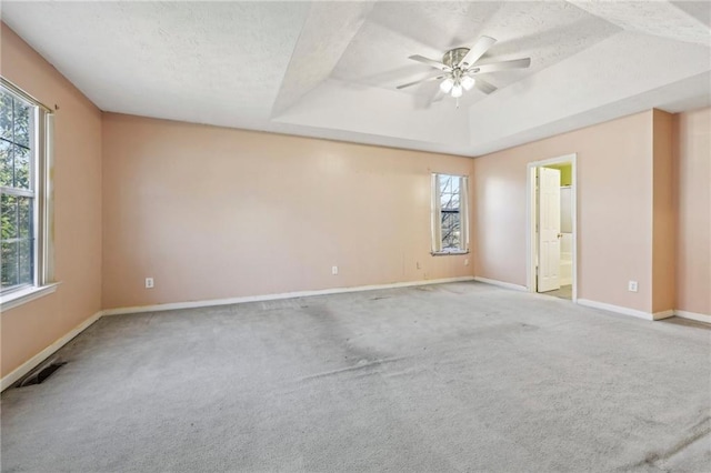 1056 Shadow Lake Dr, Lithonia, GA 30058 - carpeted spare room featuring healthy amount of natural light, a raised ceiling, ceiling fan, and a textured ceiling