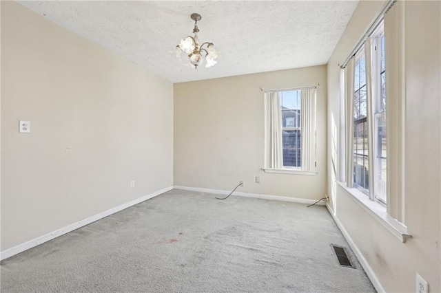 1056 Shadow Lake Dr, Lithonia, GA 30058 - empty room with a textured ceiling, a chandelier, and carpet flooring