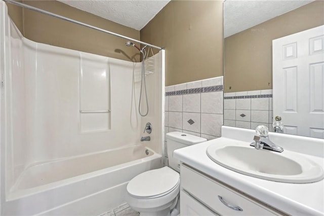 1056 Shadow Lake Dr, Lithonia, GA 30058 - full bathroom featuring vanity, tub / shower combination, a textured ceiling, wainscoting, and tile walls