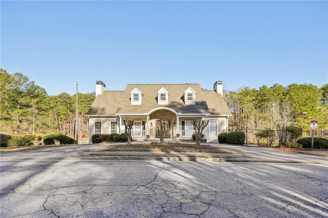 1056 Shadow Lake Dr, Lithonia, GA 30058 - cape cod-style house with a chimney and a porch