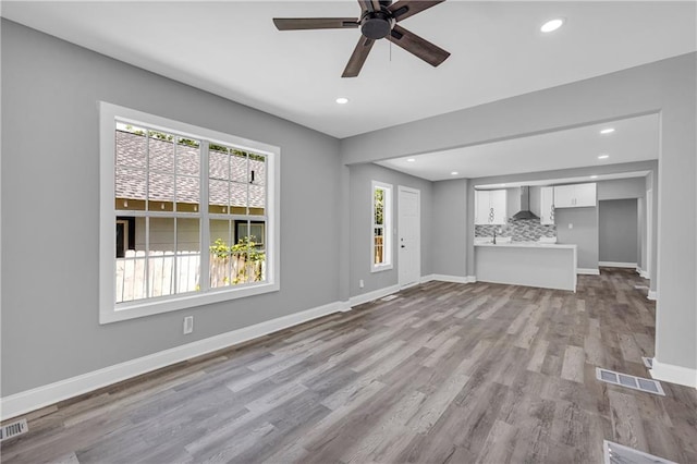 85 Ollie St, Atlanta, GA 30314 - unfurnished living room with ceiling fan, recessed lighting, and wood finished floors