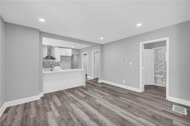 85 Ollie St, Atlanta, GA 30314 - unfurnished living room with dark wood-style flooring and recessed lighting