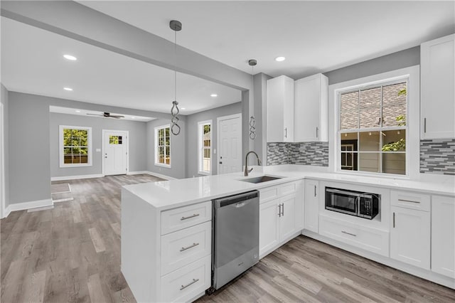85 Ollie St, Atlanta, GA 30314 - kitchen with appliances with stainless steel finishes, recessed lighting, tasteful backsplash, open floor plan, and light countertops