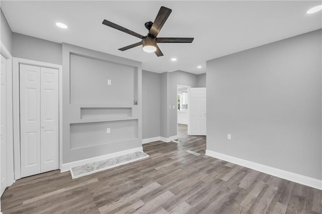 85 Ollie St, Atlanta, GA 30314 - unfurnished living room with wood finished floors, a ceiling fan, built in shelves, and recessed lighting