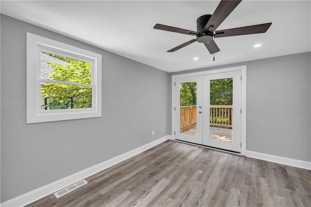 85 Ollie St, Atlanta, GA 30314 - empty room with french doors, wood finished floors, a ceiling fan, and recessed lighting