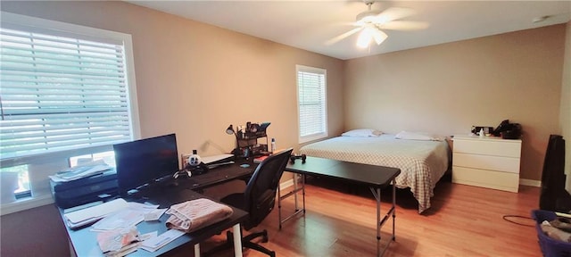 bedroom with ceiling fan and wood-type flooring