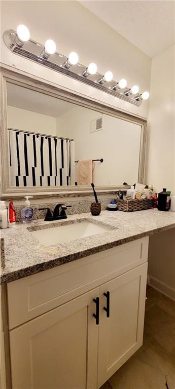 bathroom featuring tile flooring and vanity