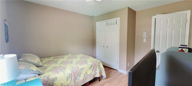 bedroom with a closet and hardwood / wood-style floors