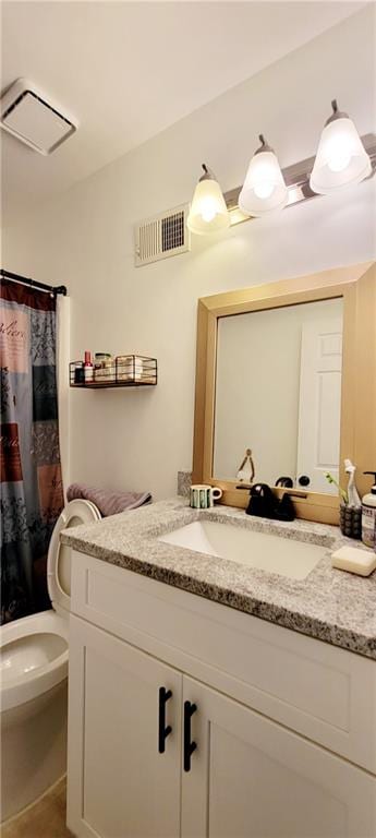 bathroom featuring vanity and toilet