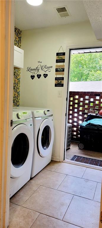 washroom featuring independent washer and dryer and light tile floors