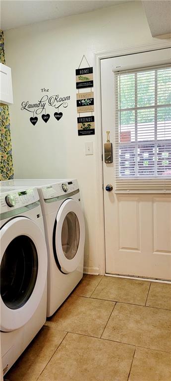 washroom with independent washer and dryer and light tile floors