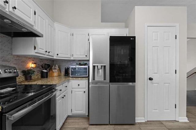 kitchen featuring white cabinets, under cabinet range hood, tasteful backsplash, and stainless steel appliances