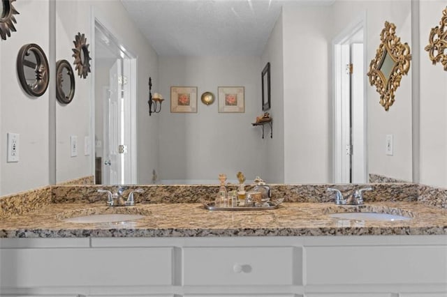 bathroom featuring double vanity and a sink