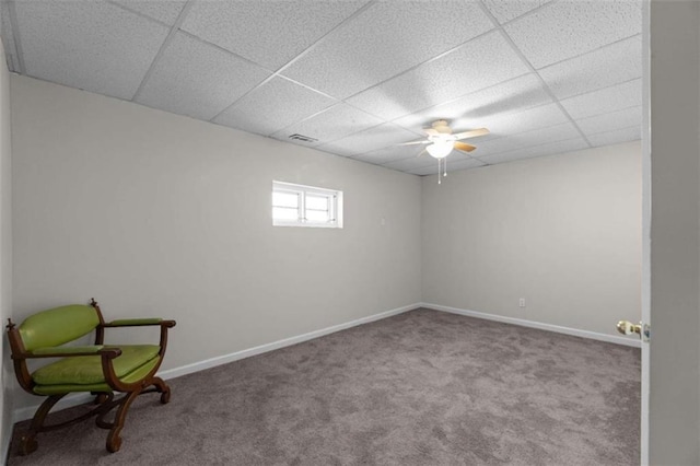 unfurnished room with carpet floors, a paneled ceiling, visible vents, and baseboards