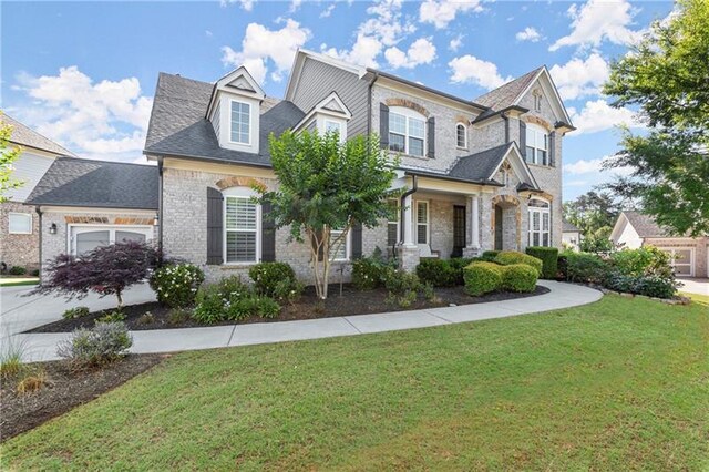 view of front of home with a garage and a front lawn