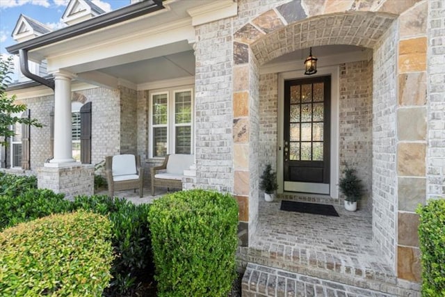 view of exterior entry with covered porch