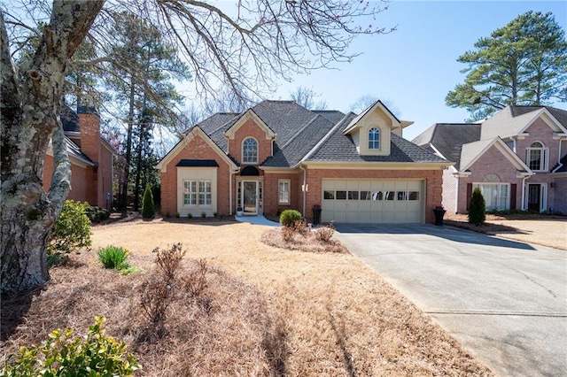 view of front of house featuring a garage, concrete driveway, brick siding, and roof with shingles