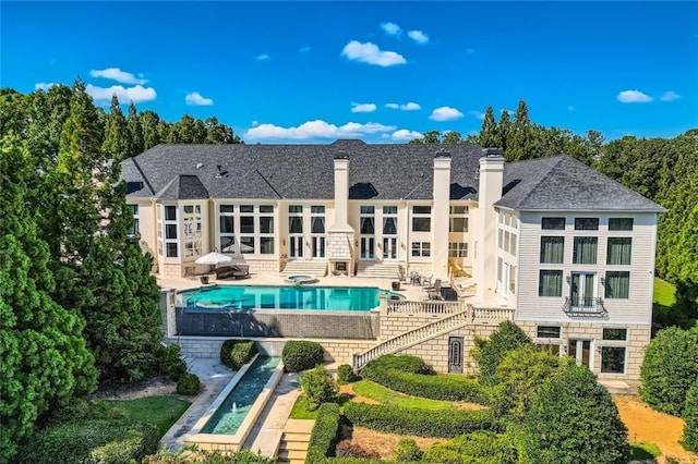 9620 Cedar Grove Rd, Chattahoochee Hills, GA 30213 - back of house featuring a chimney, a patio area, french doors, and an outdoor pool