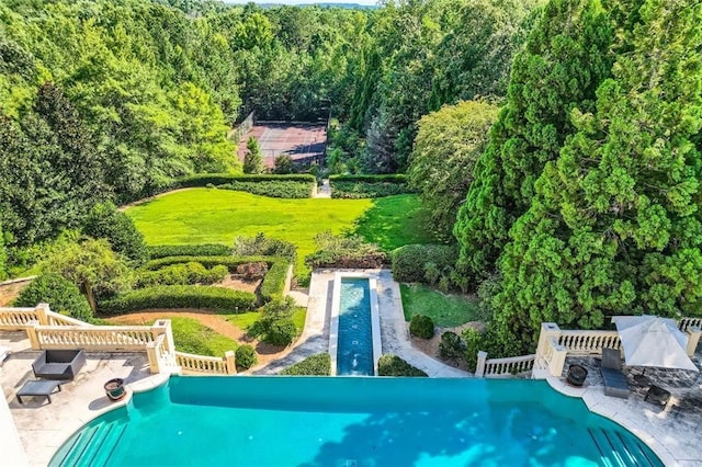 9620 Cedar Grove Rd, Chattahoochee Hills, GA 30213 - view of swimming pool featuring an infinity pool, a wooded view, and a wooden deck