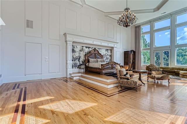 9620 Cedar Grove Rd, Chattahoochee Hills, GA 30213 - bedroom with a decorative wall, a chandelier, wood finished floors, and multiple windows