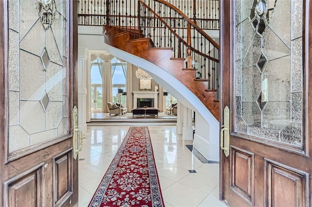 9620 Cedar Grove Rd, Chattahoochee Hills, GA 30213 - entrance foyer featuring arched walkways, stairs, inlaid floor details, light tile patterned floors, and a high ceiling