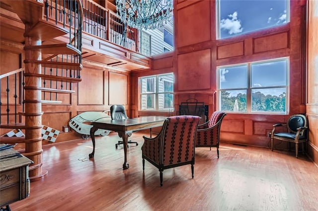 9620 Cedar Grove Rd, Chattahoochee Hills, GA 30213 - office area with wood finished floors, a decorative wall, a fireplace, a high ceiling, and a chandelier