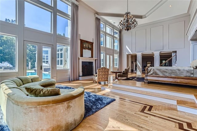 9620 Cedar Grove Rd, Chattahoochee Hills, GA 30213 - bedroom featuring a towering ceiling, a chandelier, access to exterior, multiple windows, and ornamental molding