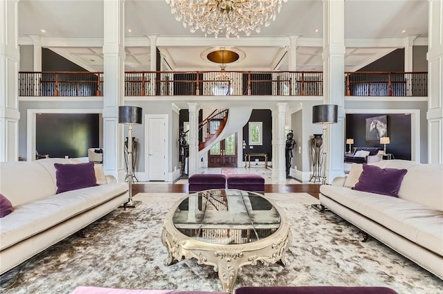 9620 Cedar Grove Rd, Chattahoochee Hills, GA 30213 - living area featuring ornate columns, a high ceiling, stairway, a chandelier, and ornamental molding