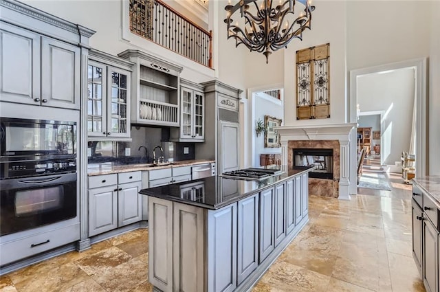 9620 Cedar Grove Rd, Chattahoochee Hills, GA 30213 - kitchen featuring gray cabinets, a towering ceiling, a chandelier, appliances with stainless steel finishes, and a center island