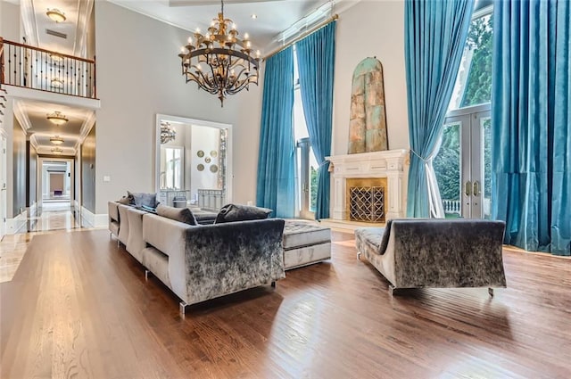 9620 Cedar Grove Rd, Chattahoochee Hills, GA 30213 - living room with a high ceiling, ornamental molding, a chandelier, and wood finished floors