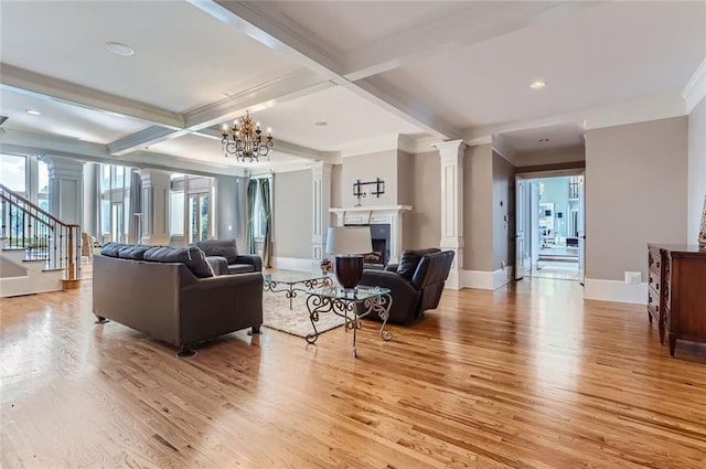 9620 Cedar Grove Rd, Chattahoochee Hills, GA 30213 - living area featuring decorative columns, light wood-type flooring, beamed ceiling, a fireplace, and stairway