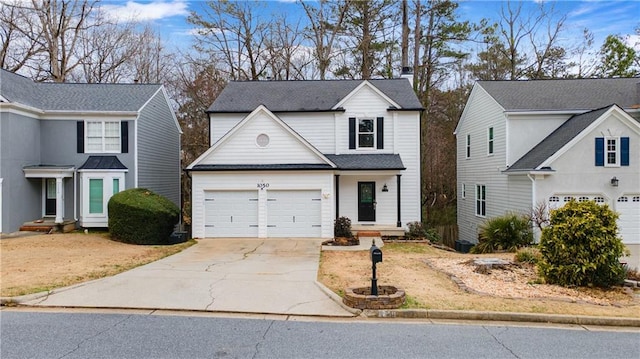 traditional home featuring a garage and driveway