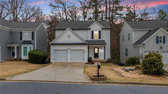 traditional-style house with driveway and an attached garage