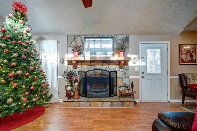 living room with a wealth of natural light, hardwood / wood-style floors, and a textured ceiling