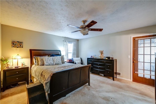 bedroom with light carpet, a textured ceiling, and ceiling fan