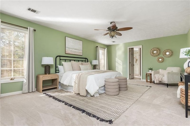 bedroom featuring visible vents, multiple windows, carpet, and baseboards