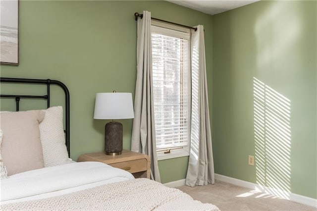 carpeted bedroom featuring baseboards