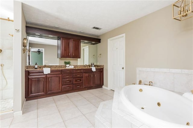 full bath with visible vents, tile patterned flooring, double vanity, tiled shower, and a whirlpool tub