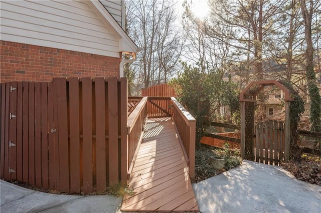 wooden terrace with a gate and fence