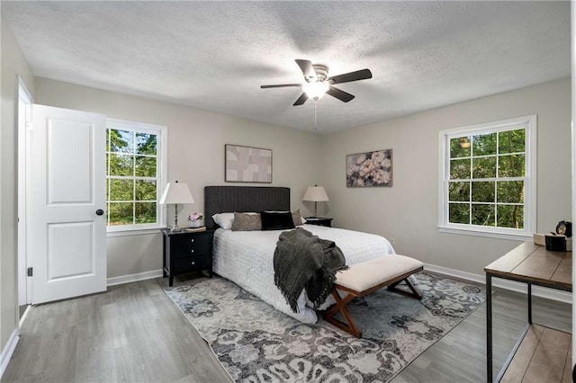 2694 Hickory Valley Dr, Snellville, GA 30078 - bedroom with wood finished floors, a textured ceiling, and ceiling fan