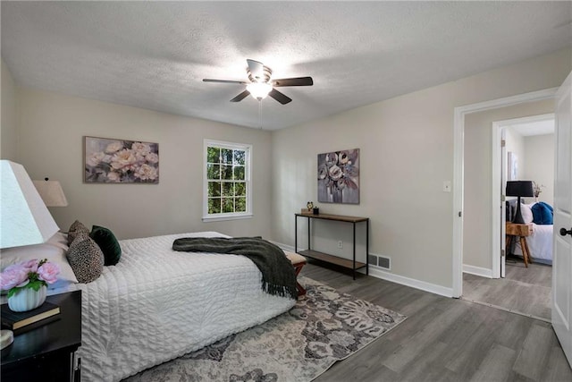 2694 Hickory Valley Dr, Snellville, GA 30078 - bedroom with wood finished floors, a textured ceiling, and a ceiling fan