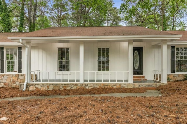 2694 Hickory Valley Dr, Snellville, GA 30078 - view of front of house with a porch, roof with shingles, and board and batten siding