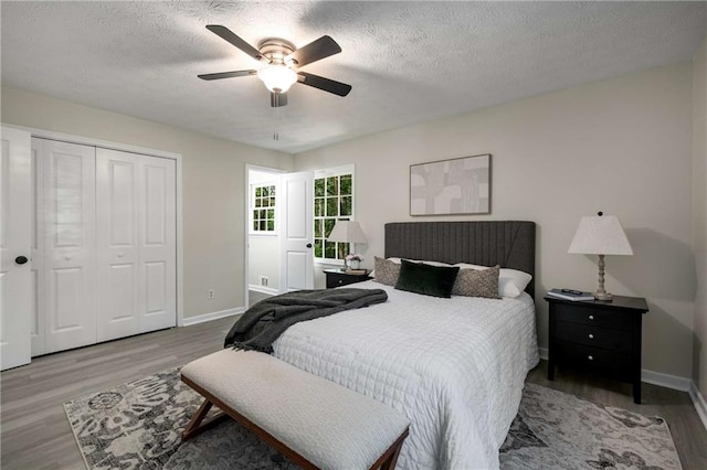 2694 Hickory Valley Dr, Snellville, GA 30078 - bedroom featuring wood finished floors, a closet, a ceiling fan, and a textured ceiling